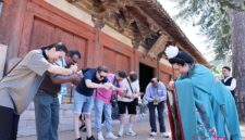 Guests on the “Discovering Shanxi’s Ancient Chinese Architecture” tour practice the Tang-style hand-over-chest salute at Foguang Temple in Xinzhou.
